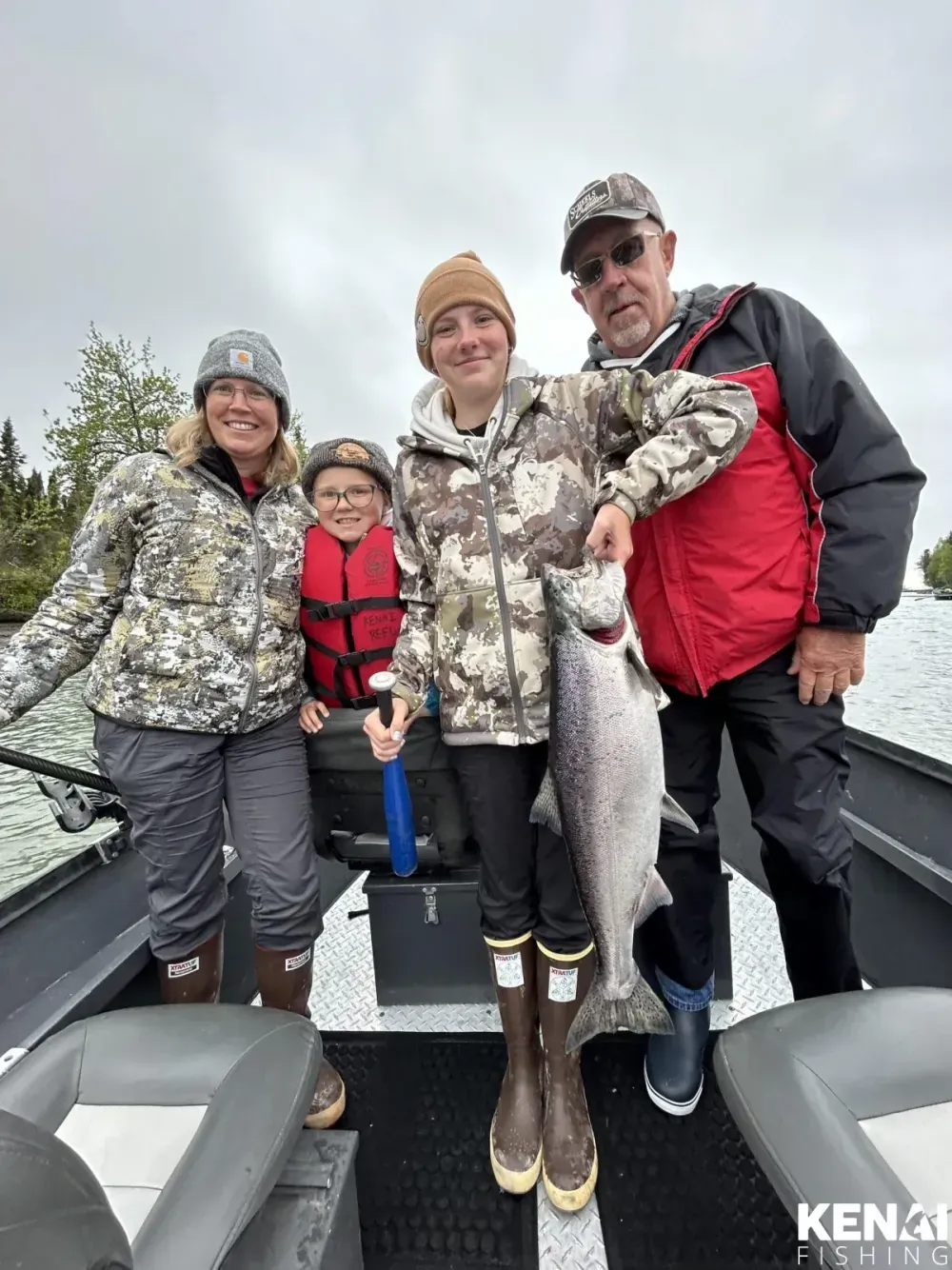 Angler fighting large king salmon on the Kenai